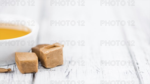 Caramel Sirup on a vintage background as detailed close-up shot (selective focus)