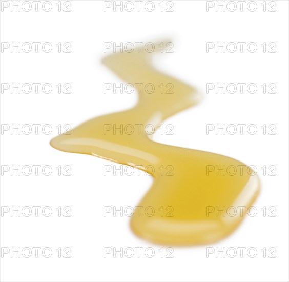 Syrup (Caramel taste) isolated on white background (selective focus, close-up shot)