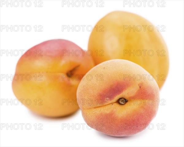 Portion of Apricots (as close-up shot) isolated on white background