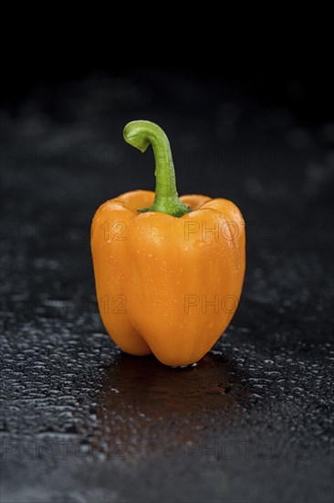 Fresh made Orange paprika on a slate slab (close-up shot, selective focus)