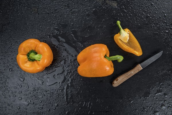 Some healthy Orange paprika on a vintage slate slab (selective focus)
