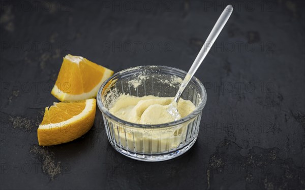 Orange fruit powder on a slate slab (selective focus, close-uo shot)
