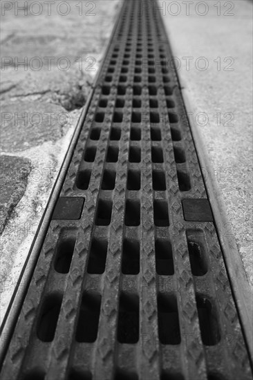 View over an iron grate, blurred background, black and white, Cologne, Germany, Europe