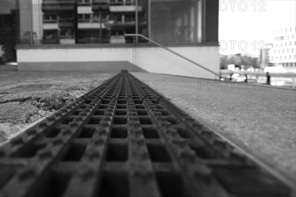 View over an iron grate, blurred background, black and white, Cologne, Germany, Europe