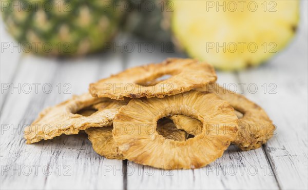 Dried Pineapple Rings on a vintage background as detailed close-up shot, selective focus