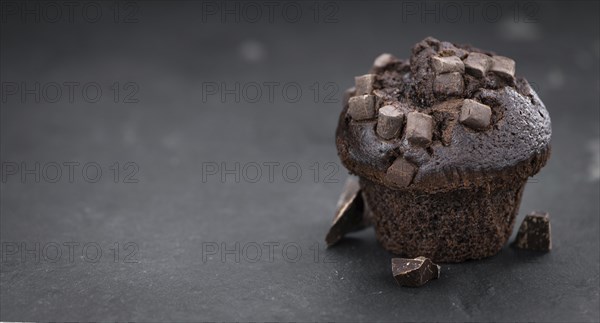 Portion of healthy Chocolate Muffins on a slate slab (selective focus)