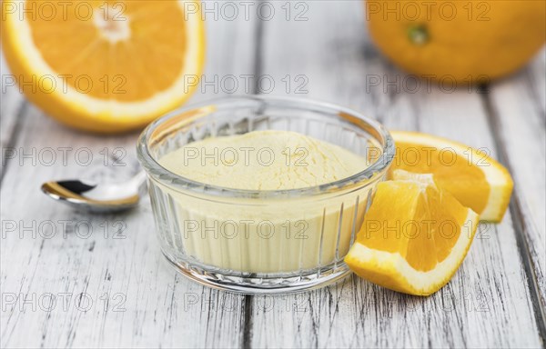 An old wooden table with orange fruit powder (selective focus)