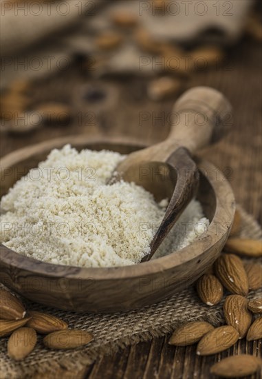 Portion of fresh Powdered Almonds on an old wooden table