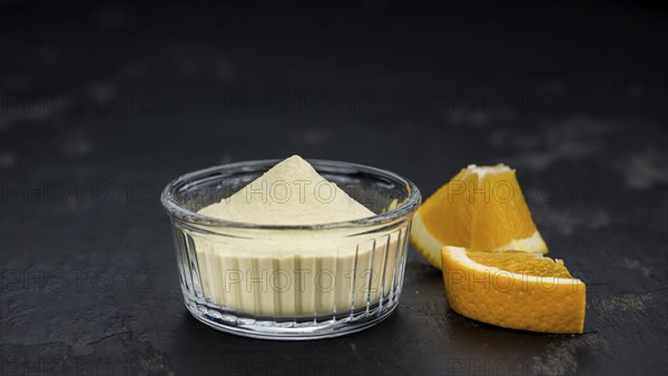 Fresh made Orange fruit Powder as detailed close-up shot (selective focus)