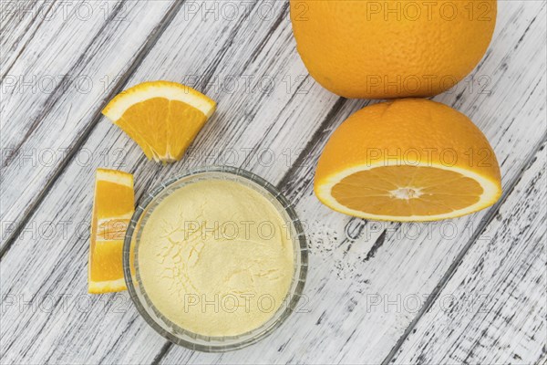 An old wooden table with orange fruit powder (selective focus)