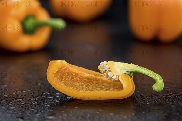 Fresh made Orange paprika on a slate slab (close-up shot, selective focus)