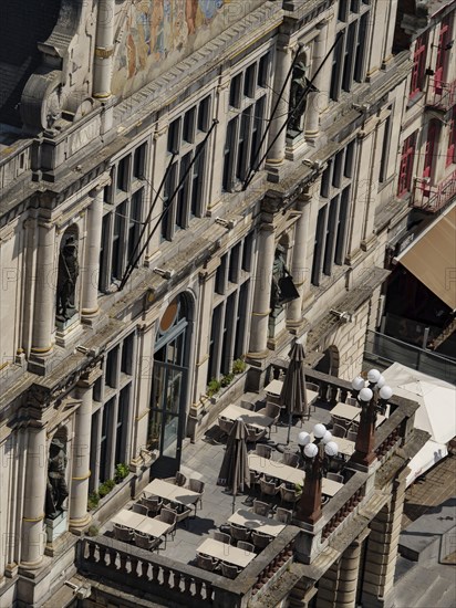 Large balcony of a historic building with chairs, tables and statues, Ghent, Belgium, Europe
