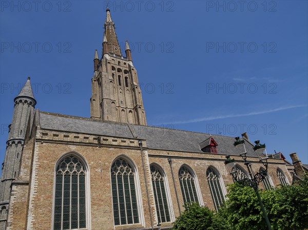 Large Gothic church with towers and large windows in Bruges on a sunny day, Bruges, Belgium, Europe