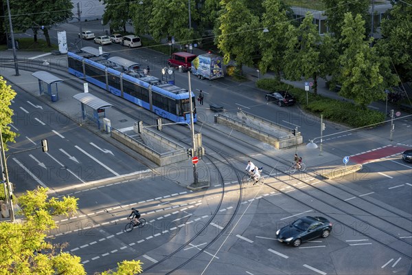 View from above of a road crossing with tram and tram stop, cyclist and a car crossing the crossing, Stiglmaierplatz, Munich, Upper Bavaria, Bavaria, Germany, Europe