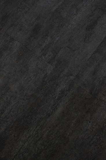 Vertical image of the texture of a dark gray and black tile, AI generated