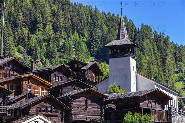 Old wooden houses in the historic centre of Grimentz, with the church of Saint Theodule, Val d'Anniviers, Valais Alps, Canton Valais, Switzerland, Europe