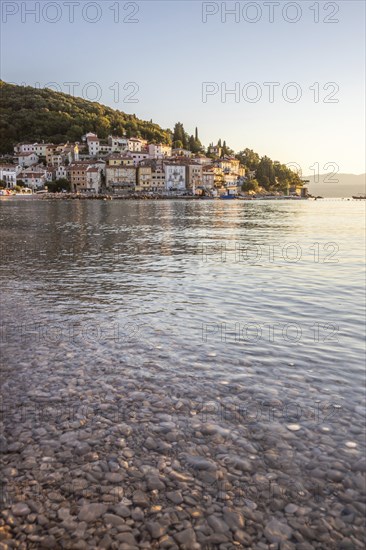 Beautiful historic skyline of a village on the Mediterranean, taken in the morning at sunrise on the beach and by the sea. Dreamlike harbour landscape in Moscenicka Draga, Moscenicka Draga, Istria, Croatia, Europe