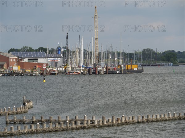 Harbour with many sailing boats and buildings along the shore under a cloudy sky, Kappeln, Schleswig-Holstein, Germany, Europe