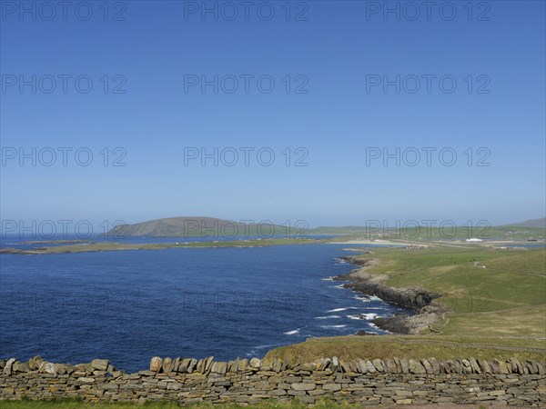 Extensive coastal landscape with green fields, stone walls and blue sky, Lerwick, Shetlands, Scotland, Great Britain