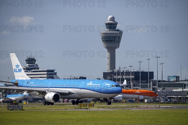 Aircraft at Amsterdam Schiphol Airport, on the taxiway for take-off on the Aalsmeerbaan, 18L/36R, KLM Airbus A330-303, air traffic control tower, terminal, Netherlands