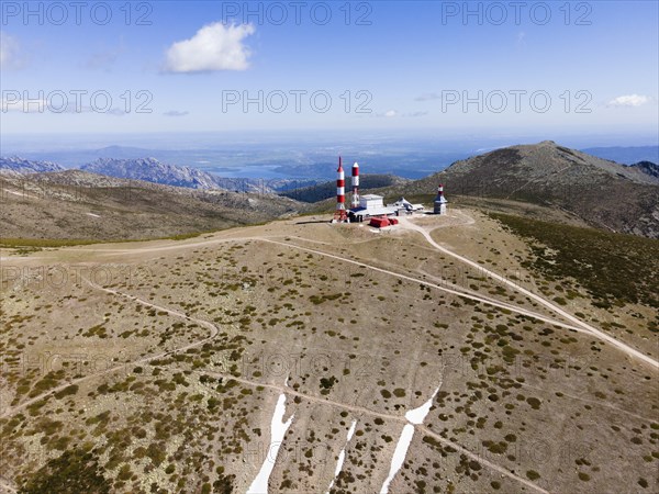 Hilly landscape with radar towers, rugged paths and a wide view under a slightly cloudy sky, aerial view, Bola del Mundo peak, Alto de las Guarramillas, National Park, Guadarrama Mountains, Madrid, Spain, Europe