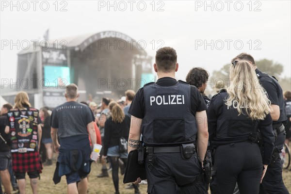 Policemen in front of the Louder stage at the Wacken Open Air in Wacken. The traditional metal festival takes place from 31 July to 2 August 2024