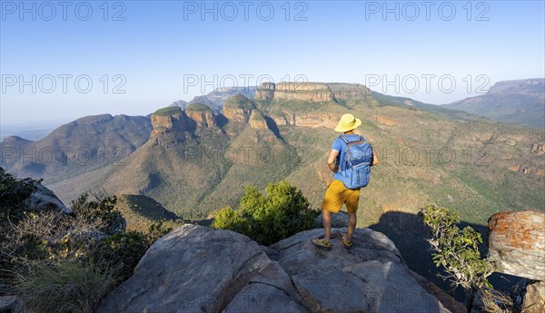 Tourist enjoying the view of the canyon, Blyde River Canyon with Three Rondawels peak, View of canyon with Blyde River and Table Mountains, Canyon landscape in the evening light, Three Rondavels Viewpoint, Panorama Route, Mpumalanga, South Africa, Africa