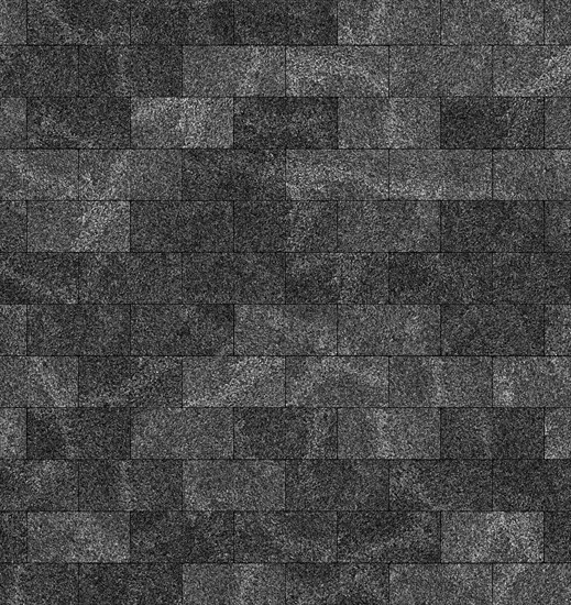 A close-up of textured grey roof shingles forming a rough, patterned surface