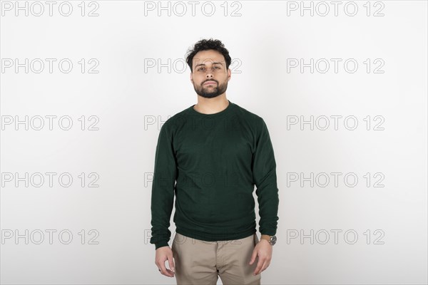 Portrait of young man with serene expression looking at the camera