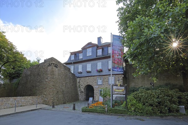 Gatehouse with backlight with flag, Siegerland Museum, inscription, Upper Castle built 14th century, Siegen, Siegerland, North Rhine-Westphalia, Germany, Europe