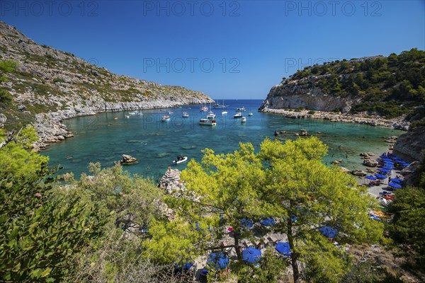 Beach umbrellas and sunbeds, turquoise waters, Anthony Quinn Bay, Faliraki, Rhodes, Dodecanese, Greece, Europe