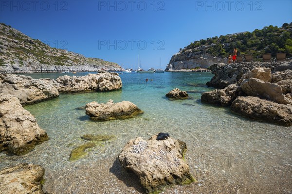 Beach umbrellas and sunbeds, turquoise waters, Anthony Quinn Bay, Faliraki, Rhodes, Dodecanese, Greece, Europe