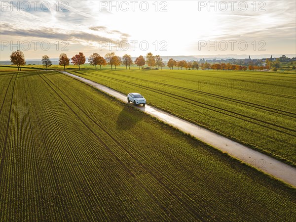 Aerial view of a VW ID4 electric car at sunrise in autumn, Herrenberg, Germany, Europe