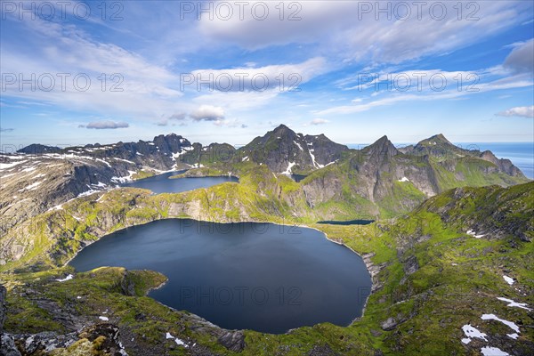 Mountain landscape with steep rocky peaks and lake Tennesvatnet and Krokvatnet, in the back peak of Hermannsdalstinden, view from the top of MunkenMoskenesoya, Lofoten, Nordland, Norway, Europe