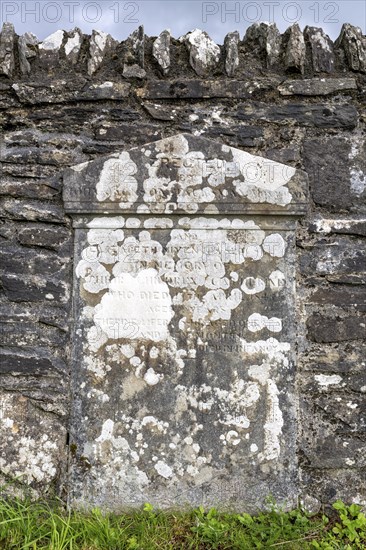 Old, weathered gravestone on the cemetery wall in Kilmartin, Argyll and Bute, Scotland, Great Britain