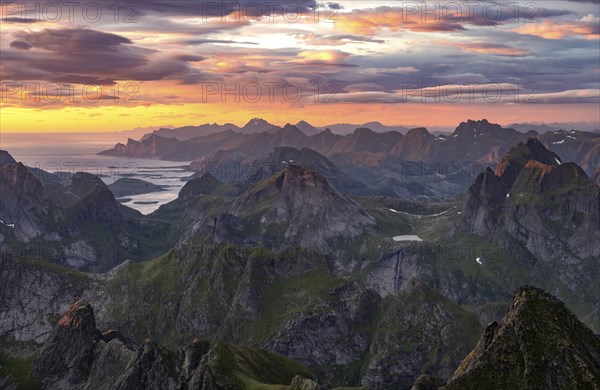 View over mountain top and sea, dramatic sunset, from the top of Hermannsdalstinden, Moskenesöy, Lofoten, Nordland, Norway, Europe