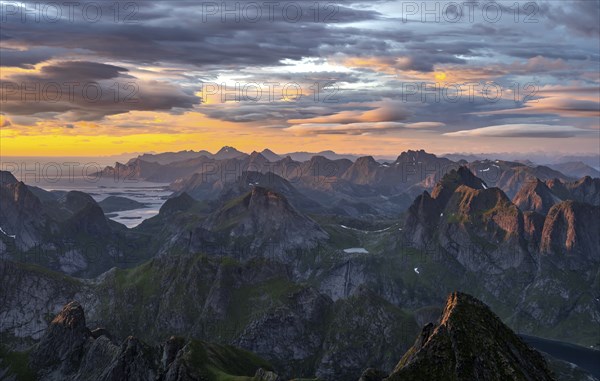 View over mountain top and sea, dramatic sunset, from the top of Hermannsdalstinden, Moskenesöy, Lofoten, Nordland, Norway, Europe