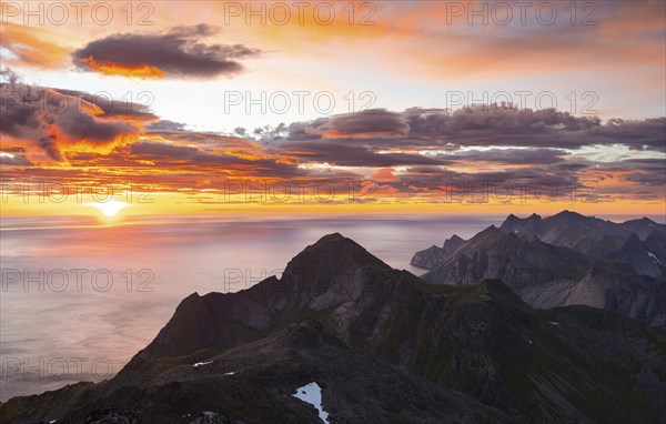 View over mountain top and sea, dramatic sunset, from the top of Hermannsdalstinden, Moskenesöy, Lofoten, Nordland, Norway, Europe
