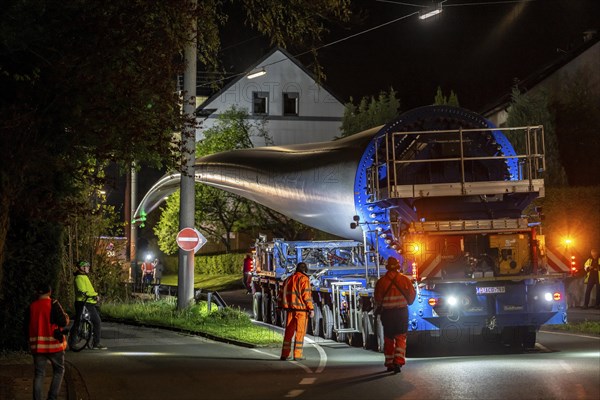 Transport of a 68 metre long, 22 tonne blade of a wind turbine, here in Schwelm, with a self-propelled Blade-Lifter vehicle, over a 40 km long route, over 2 nights, in the Bergisches Land, through towns, villages, over country roads, narrow through roads, to the construction site of the wind turbine near Hagen, North Rhine-Westphalia, Germany, Europe