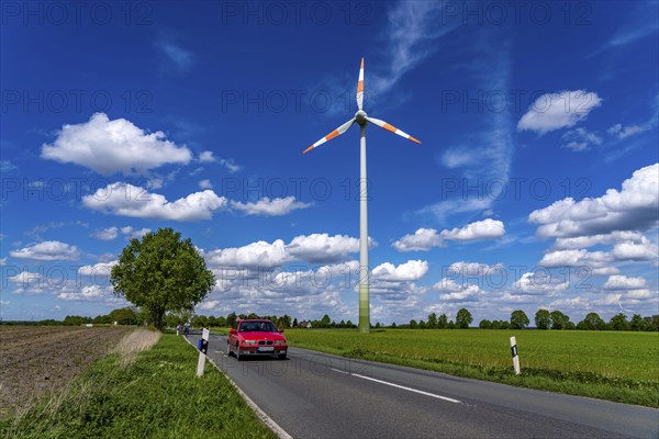 Wind turbine, wind energy plant from the manufacturer Enercon, blue sky with many white clouds, near Schermbeck, country road, Bestener Straße, North Rhine-Westphalia, Germany, Europe