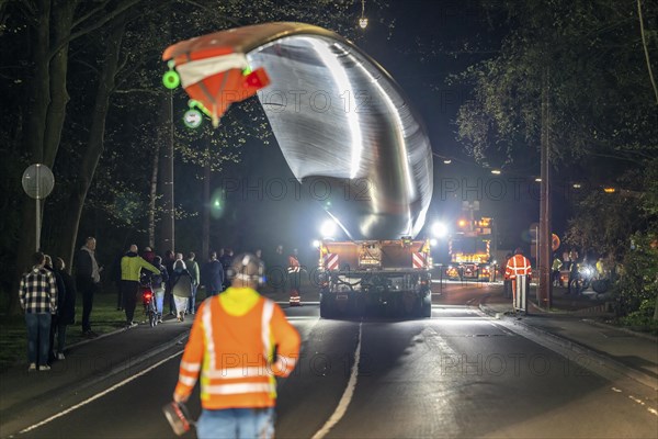 Transport of a 68 metre long, 22 tonne blade of a wind turbine, here in Schwelm, with a self-propelled Blade-Lifter vehicle, over a 40 km long route, over 2 nights, in the Bergisches Land, through towns, villages, over country roads, narrow through roads, to the construction site of the wind turbine near Hagen, North Rhine-Westphalia, Germany, Europe