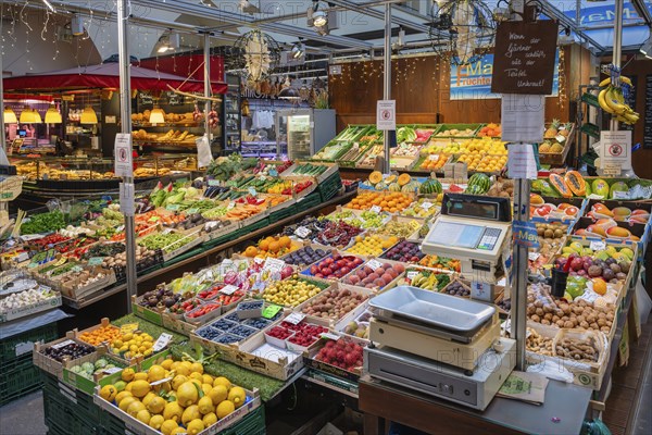 Market stall with a wide range of different tropical fruits and vegetables in the Markthalle Stuttgart, Baden-Württemberg, Germany, Europe