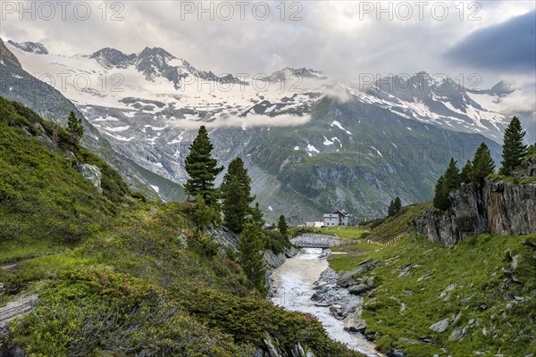 Mountain landscape with mountain stream Zemmbach and mountain hut Berliner Hütte, behind mountain peak Großer Möseler with glacier Waxeggkees, Berliner Höhenweg, Zillertal Alps, Tyrol, Austria, Europe