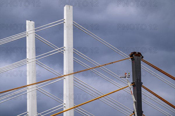 The new Rhine bridge Neuenkamp, the A40, white pillar ropes, and the old motorway bridge, which is being dismantled, preparation for demolition, workers on cherry pickers measure, mark the old bridge pillar, Duisburg, North Rhine-Westphalia, Germany, Europe