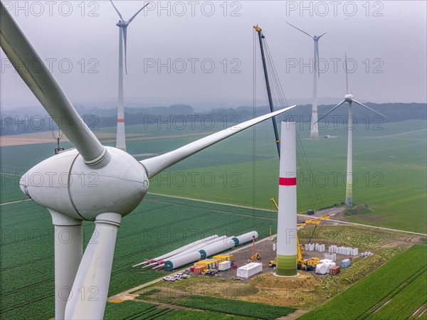 Erection of the tower of a wind power plant in a wind farm near Issum, 9 older wind turbines from the manufacturer Enercon (model series E-58) at the rear right and front, which have been in operation for over two decades, will be replaced by a total of four Enercon E-160 turbines, under construction, with a total output of 22 megawatts, Lower Rhine, North Rhine-Westphalia, Germany, Europe