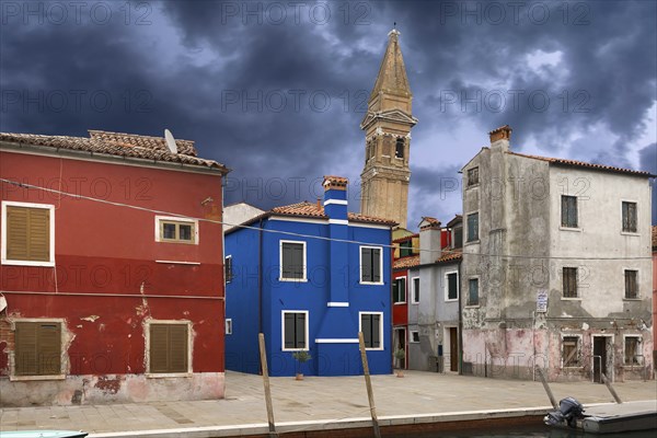 Colourful residential buildings, behind the leaning tower of the church of St. Martin Vescovo, 16th century, Burano, Venice, Veneto, Italy, Europe