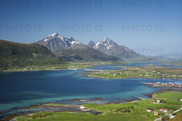 Landscape with sea and mountains, view from Hornsheia to Mount Himmeltindan. Good weather, blue sky. Early summer. Hornsheia, Haug, Vestvagoya, Lofoten, Norway, Europe