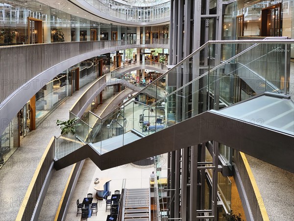 Stilwerk Düsseldorf, free-floating staircase in the elliptical atrium with surrounding galleries on five sales floors, Germany, Europe
