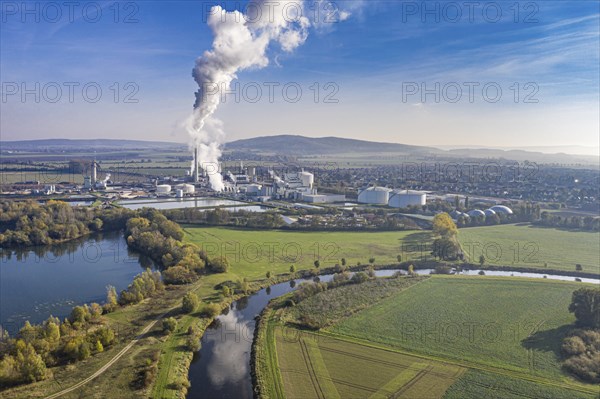 Drone shot of river Leine with Nordzucker sugar factory in Nordstemmen, smoking chimneys on a cold and sunny day, Germany, Europe