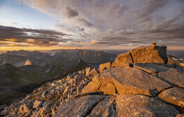 View over mountain top and sea, dramatic sunset, at the top of Hermannsdalstinden, Moskenesöy, Lofoten, Nordland, Norway, Europe